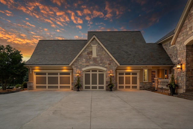 18901 Brookwood Rd, Prior Lake, MN 55372 - view of front of home featuring stone siding, a high end roof, an attached garage, and driveway