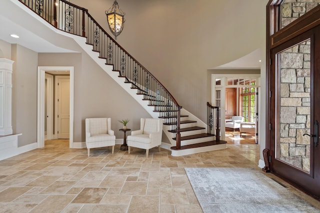 18901 Brookwood Rd, Prior Lake, MN 55372 - foyer entrance with a towering ceiling, stone tile flooring, stairway, and recessed lighting