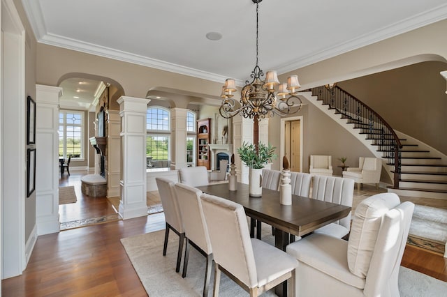 18901 Brookwood Rd, Prior Lake, MN 55372 - dining space with stairs, crown molding, arched walkways, ornate columns, and dark wood-style flooring
