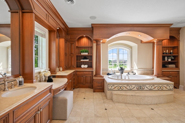 18901 Brookwood Rd, Prior Lake, MN 55372 - bathroom with decorative columns, a garden tub, vanity, and tile patterned floors