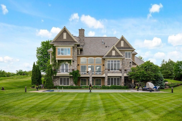 18901 Brookwood Rd, Prior Lake, MN 55372 - rear view of property with stone siding, a yard, a chimney, and a balcony