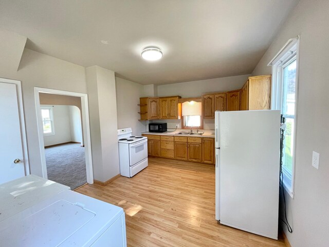422 Sanborn St, Springfield, MN 56087 - kitchen with white appliances, washer / dryer, light countertops, light wood finished floors, and open shelves