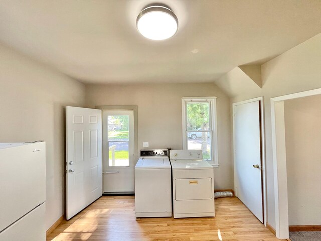 422 Sanborn St, Springfield, MN 56087 - laundry area with washing machine and clothes dryer and light wood-style floors