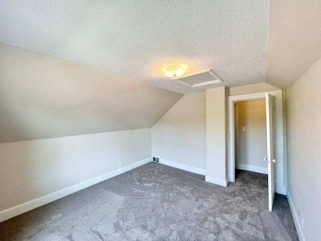 422 Sanborn St, Springfield, MN 56087 - bonus room featuring attic access, vaulted ceiling, carpet flooring, and a textured ceiling
