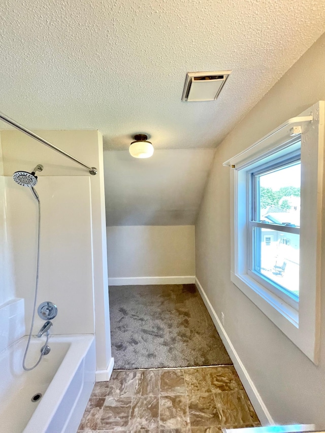 422 Sanborn St, Springfield, MN 56087 - bathroom with shower / tub combination, lofted ceiling, and a textured ceiling
