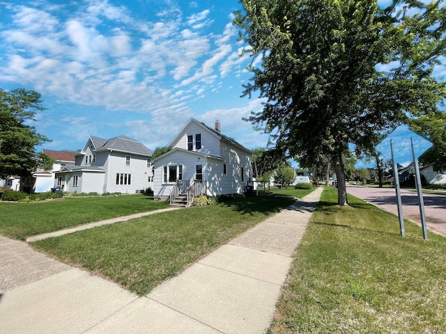 422 Sanborn St, Springfield, MN 56087 - view of property exterior with a lawn and a chimney