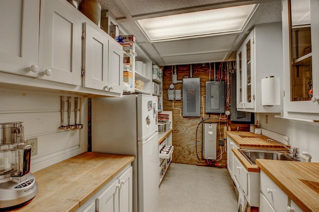 28395 Far N Dr, Nevis, MN 56467 - kitchen featuring butcher block counters, electric panel, freestanding refrigerator, and white cabinets