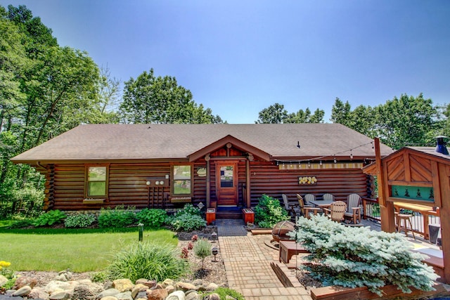 28395 Far N Dr, Nevis, MN 56467 - log cabin featuring log exterior, a front yard, roof with shingles, and a wooden deck