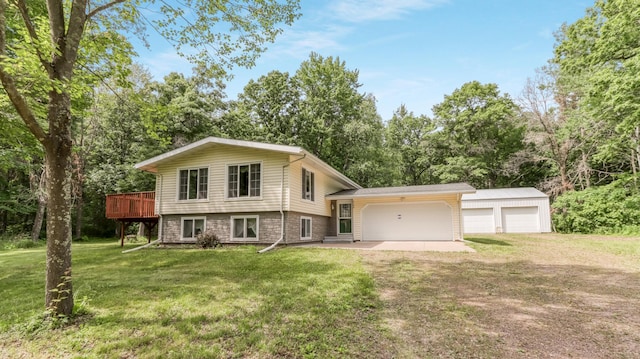 2104 US Highway 8, Stanley Twp, WI 54822 - split level home with a front yard, a wooden deck, dirt driveway, view of wooded area, and a garage