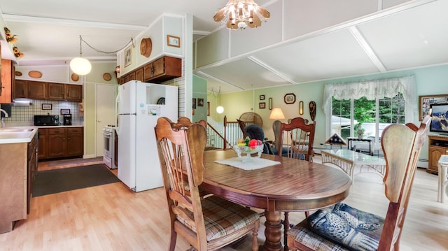 2104 US Highway 8, Stanley Twp, WI 54822 - dining room with light wood-type flooring, a baseboard heating unit, and crown molding