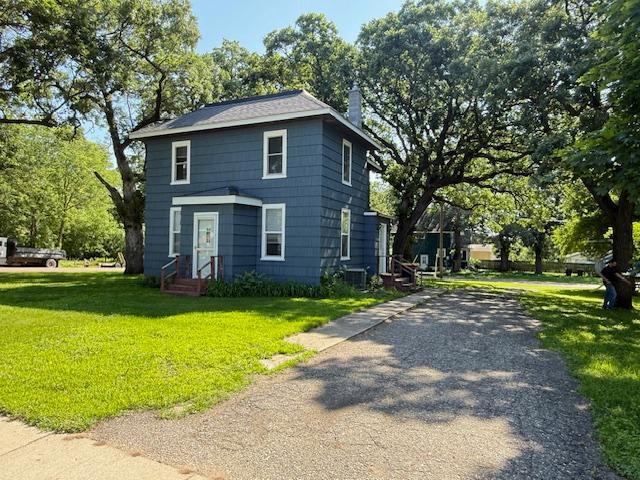 311 Grove St, Redwood Falls, MN 56283 - traditional style home with a front yard and a chimney