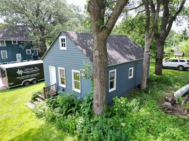 311 Grove St, Redwood Falls, MN 56283 - view of property exterior featuring a yard and a shingled roof