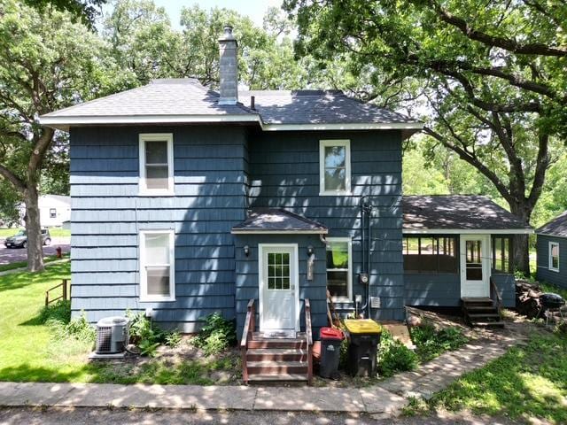 311 Grove St, Redwood Falls, MN 56283 - back of house featuring entry steps, a chimney, and roof with shingles