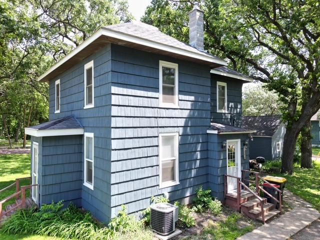 311 Grove St, Redwood Falls, MN 56283 - view of property exterior with a chimney and roof with shingles