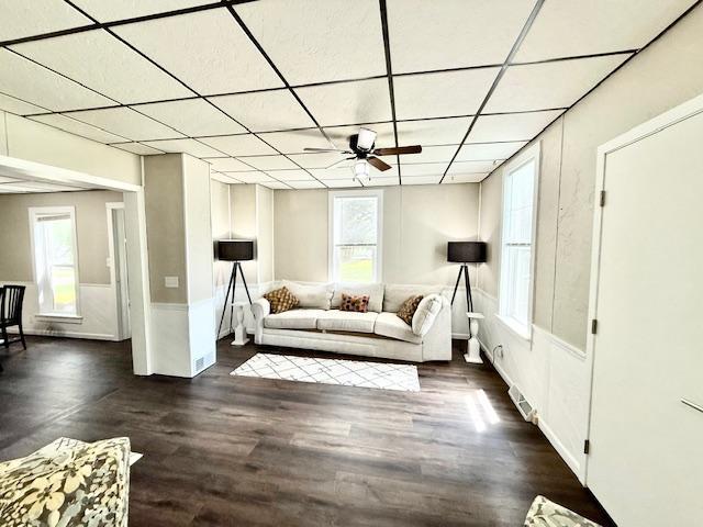 311 Grove St, Redwood Falls, MN 56283 - living room featuring a ceiling fan, a paneled ceiling, dark wood-style floors, and healthy amount of natural light