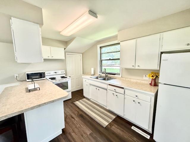 311 Grove St, Redwood Falls, MN 56283 - kitchen featuring white appliances, light countertops, white cabinets, dark wood finished floors, and beverage cooler
