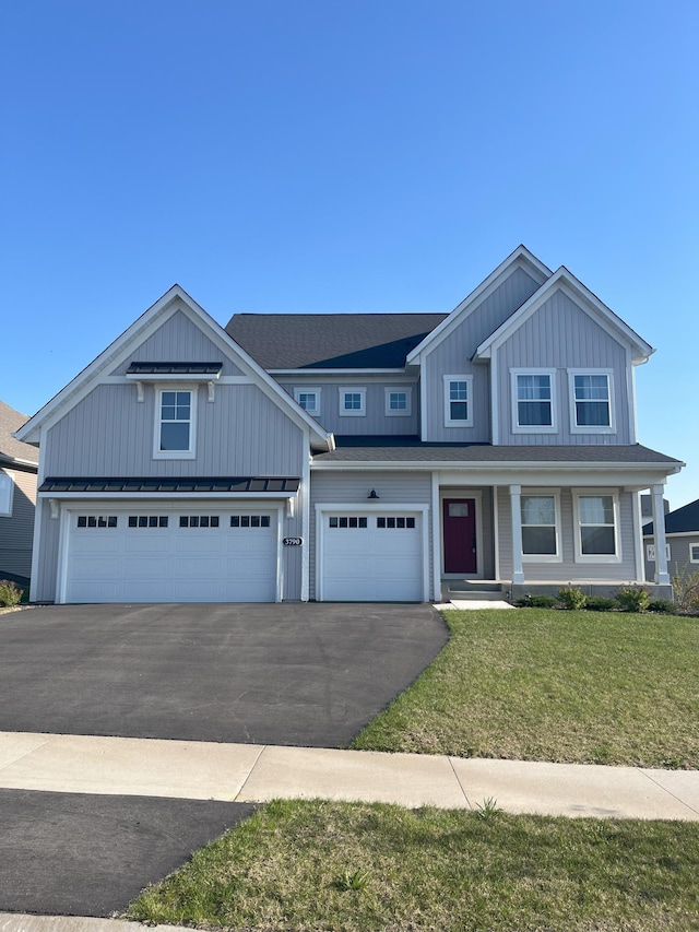 3790 Thrush St, Shakopee, MN 55379 - view of front of house featuring asphalt driveway, board and batten siding, a front lawn, a porch, and a garage