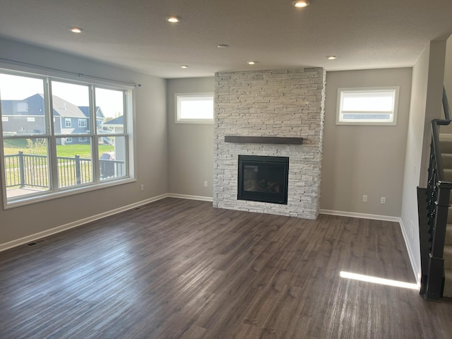3790 Thrush St, Shakopee, MN 55379 - unfurnished living room featuring stairway, dark wood-type flooring, recessed lighting, and a fireplace