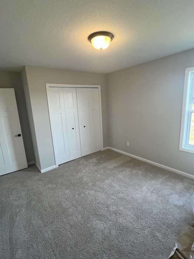 3790 Thrush St, Shakopee, MN 55379 - unfurnished bedroom with carpet floors, a closet, and a textured ceiling