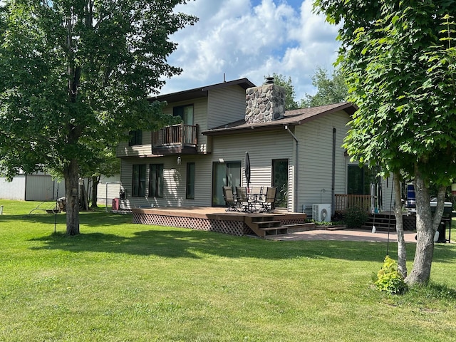 28599 Westwood Ln, Harris Twp, MN 55744 - back of property featuring a balcony, a chimney, a lawn, and a wooden deck