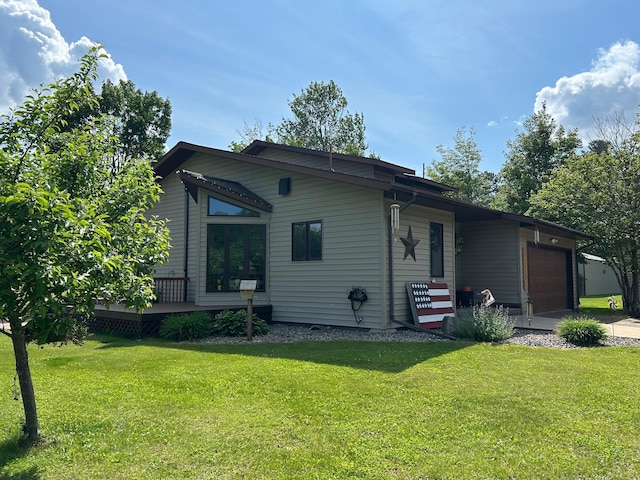 28599 Westwood Ln, Harris Twp, MN 55744 - rear view of property with a garage, a lawn, and a wooden deck