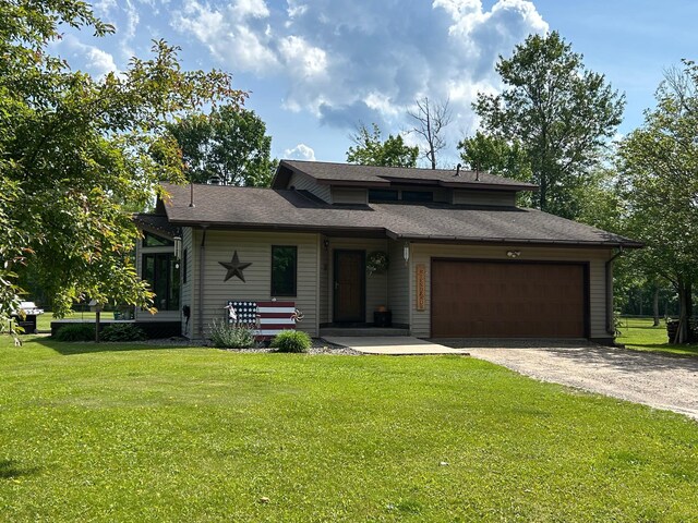28599 Westwood Ln, Harris Twp, MN 55744 - view of front facade with driveway, a garage, a front lawn, and roof with shingles