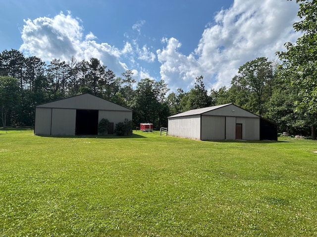 28599 Westwood Ln, Harris Twp, MN 55744 - view of green lawn with a pole building, an outbuilding, and view of scattered trees