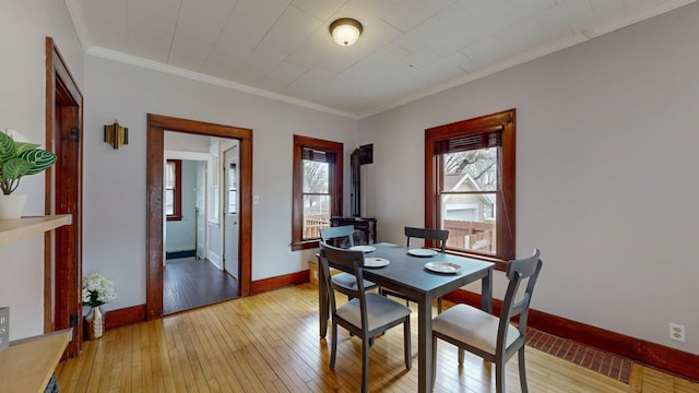 429 7th St NW, Rochester, MN 55901 - dining room with light wood-style floors and crown molding