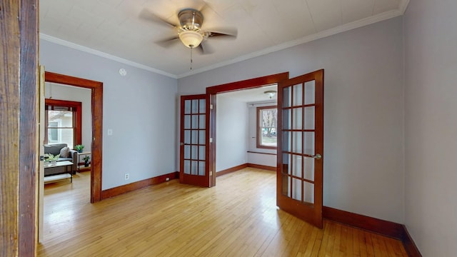 429 7th St NW, Rochester, MN 55901 - unfurnished room with french doors, plenty of natural light, hardwood / wood-style flooring, a ceiling fan, and ornamental molding