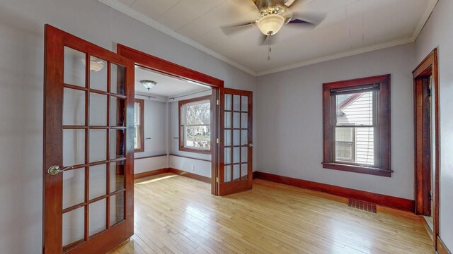 429 7th St NW, Rochester, MN 55901 - unfurnished room featuring plenty of natural light, french doors, light wood-style flooring, and crown molding