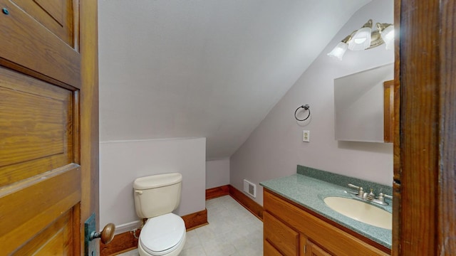 429 7th St NW, Rochester, MN 55901 - half bathroom with lofted ceiling, vanity, and tile patterned flooring