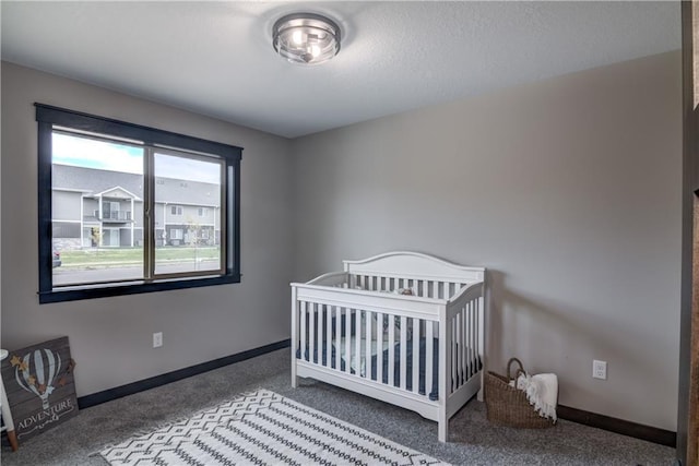 232 Chestnut St, Ellsworth, WI 54011 - carpeted bedroom featuring baseboards and a nursery area