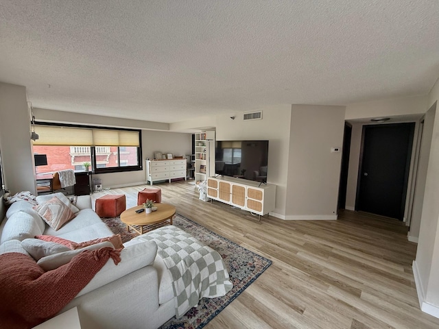26 10th St W Unit 402, Saint Paul, MN 55102 - living room with a textured ceiling and light wood finished floors