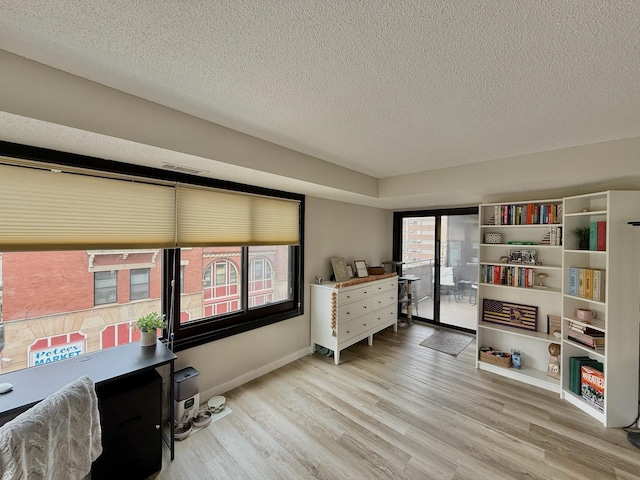 26 10th St W Unit 402, Saint Paul, MN 55102 - bedroom with wood finished floors, a textured ceiling, and access to outside