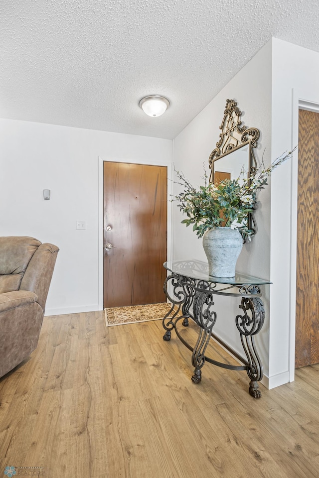 2575 Pacific Dr S Unit 301, Fargo, ND 58103 - foyer featuring wood finished floors and a textured ceiling