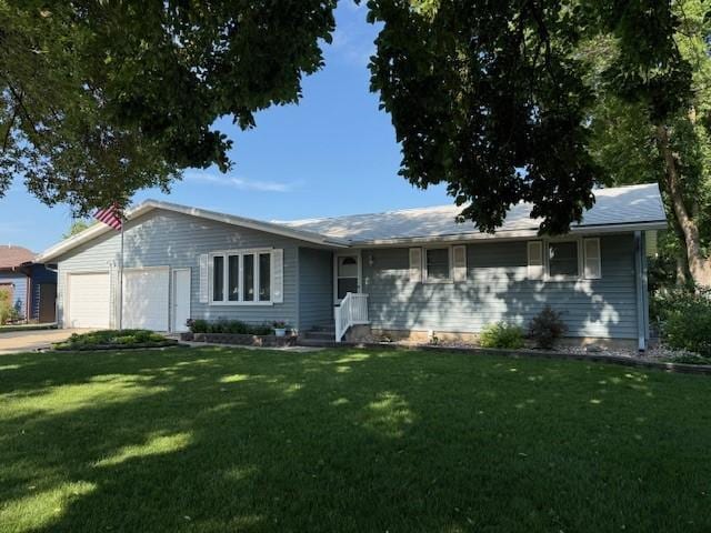 2411 Douglas St, Windom, MN 56101 - ranch-style house featuring an attached garage, a front lawn, and driveway