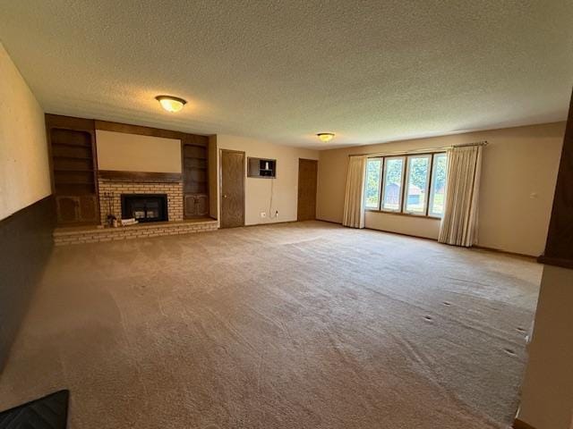 2411 Douglas St, Windom, MN 56101 - unfurnished living room featuring a textured ceiling, a brick fireplace, carpet flooring, and built in features