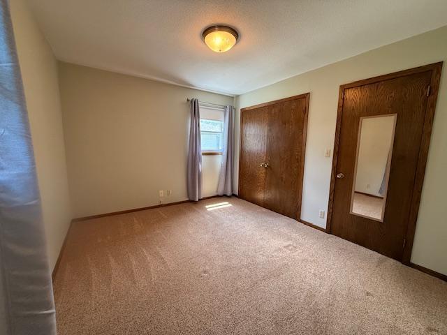 2411 Douglas St, Windom, MN 56101 - unfurnished bedroom with carpet floors and a closet