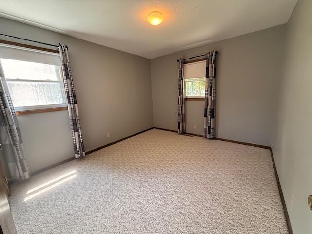 2411 Douglas St, Windom, MN 56101 - empty room with light colored carpet and baseboards