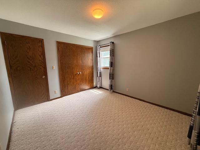 2411 Douglas St, Windom, MN 56101 - unfurnished bedroom with a closet and carpet floors