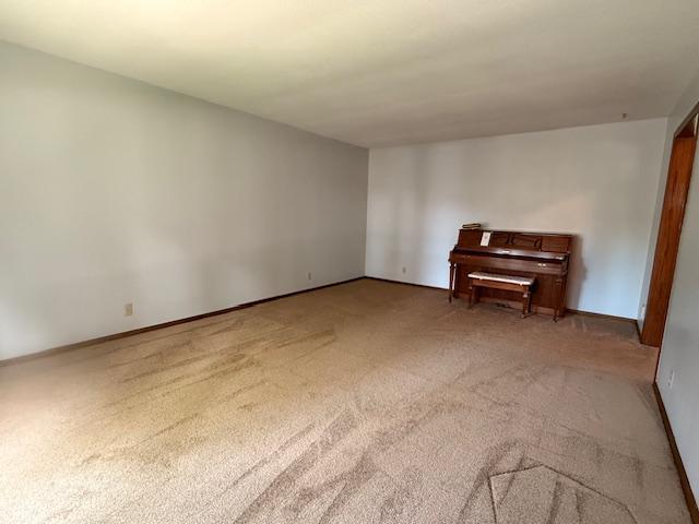 2411 Douglas St, Windom, MN 56101 - spare room featuring carpet flooring and baseboards