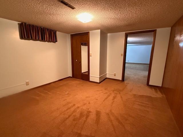 2411 Douglas St, Windom, MN 56101 - carpeted empty room with a textured ceiling