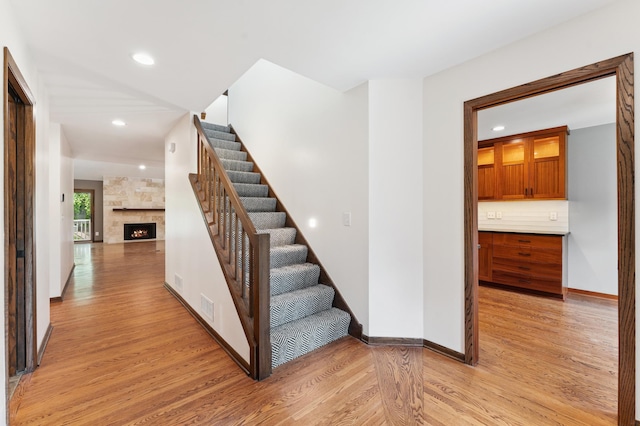 1775 Lexington Ave S Unit 26, Lilydale, MN 55118 - stairway with wood finished floors, recessed lighting, and a fireplace
