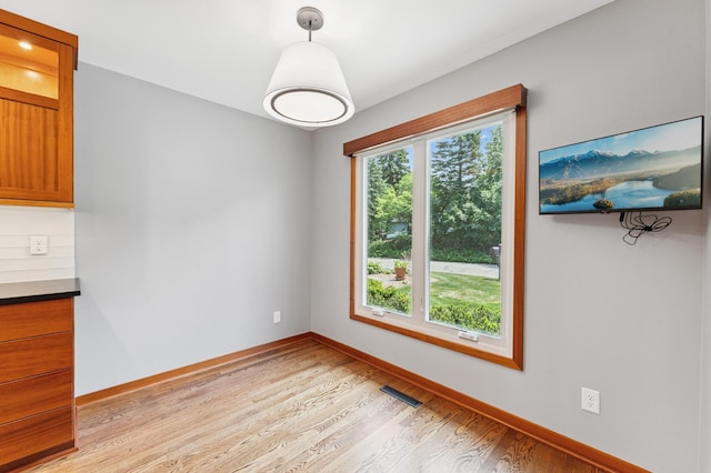 1775 Lexington Ave S Unit 26, Lilydale, MN 55118 - unfurnished dining area featuring light wood-style floors and baseboards