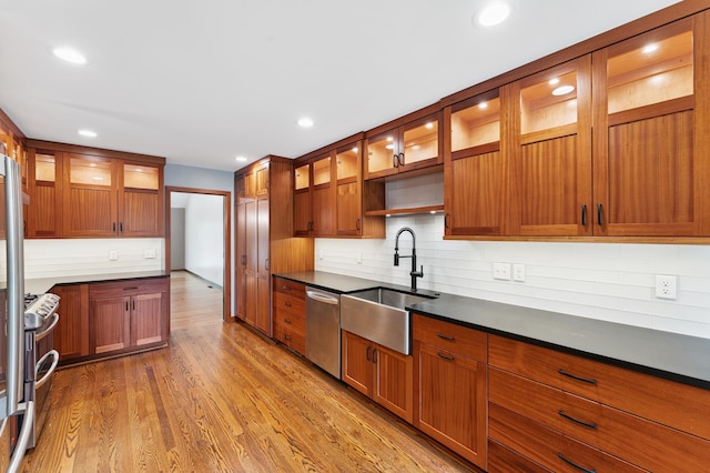 1775 Lexington Ave S Unit 26, Lilydale, MN 55118 - kitchen with appliances with stainless steel finishes, tasteful backsplash, wood finished floors, brown cabinetry, and recessed lighting