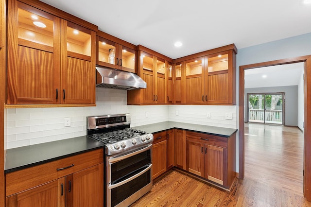 1775 Lexington Ave S Unit 26, Lilydale, MN 55118 - kitchen with range with two ovens, under cabinet range hood, light wood-style floors, dark countertops, and recessed lighting