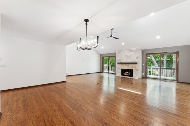 1775 Lexington Ave S Unit 26, Lilydale, MN 55118 - unfurnished living room with a chandelier, a ceiling fan, lofted ceiling, a fireplace, and wood finished floors