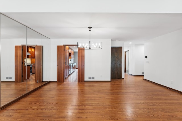 1775 Lexington Ave S Unit 26, Lilydale, MN 55118 - spare room featuring a chandelier and wood finished floors
