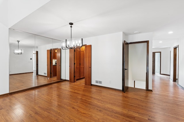 1775 Lexington Ave S Unit 26, Lilydale, MN 55118 - spare room featuring a chandelier, wood finished floors, and recessed lighting