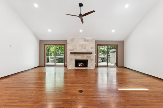 1775 Lexington Ave S Unit 26, Lilydale, MN 55118 - unfurnished living room with vaulted ceiling, healthy amount of natural light, wood finished floors, ceiling fan, and a fireplace